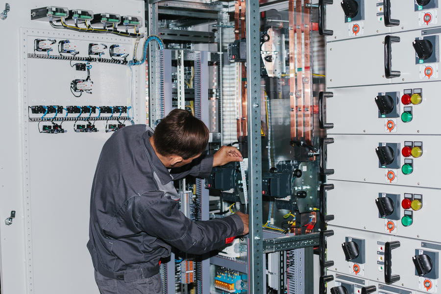Electrician near the low-voltage cabinet.